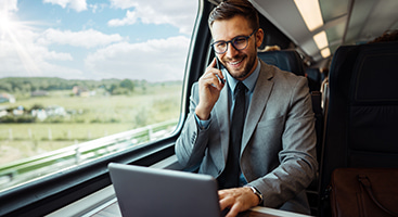 an employee uses a laptop abaord a Detroit charter bus rental