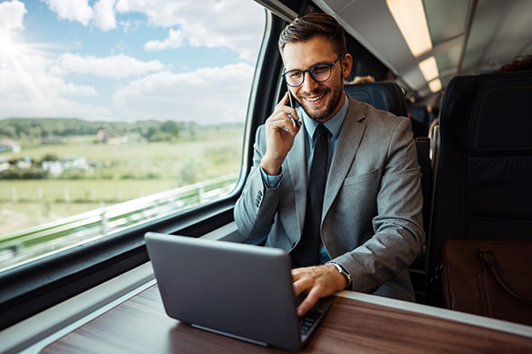 an employee uses a laptop aboard a Detroit charter bus rental